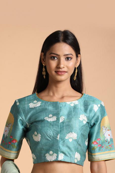 Blue coloured Pichwai printed blouse crafted from luxurious raw silk fabric.