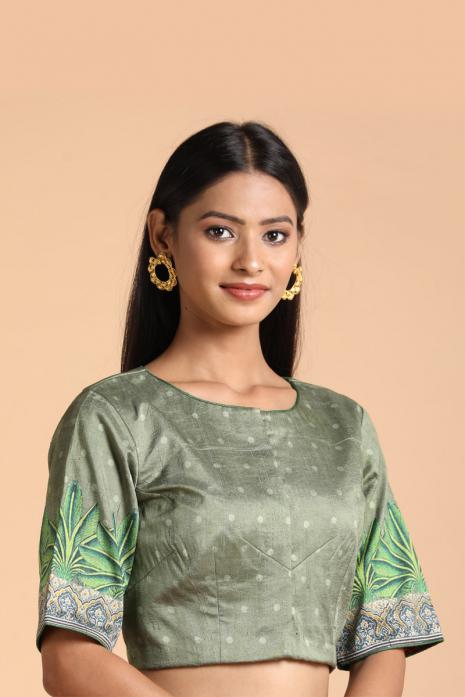 Green coloured Pichwai printed blouse crafted from luxurious raw silk fabric.