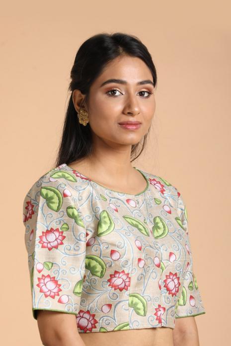 Cream coloured Pichwai printed blouse crafted from luxurious raw silk fabric.