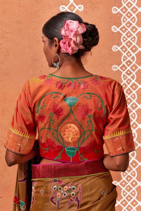 Tangerine coloured Pichwai handpainted blouse crafted from luxurious paithani silk fabric.