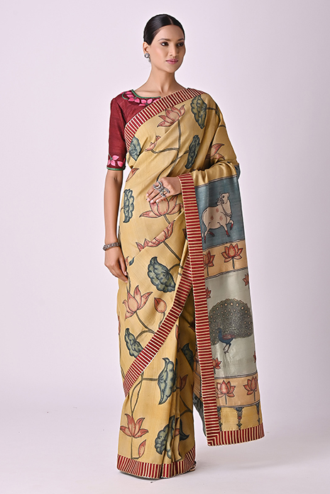 A vibrant collection of light mustard coloured handcrafted sarees with intricate Kalamkari artistry