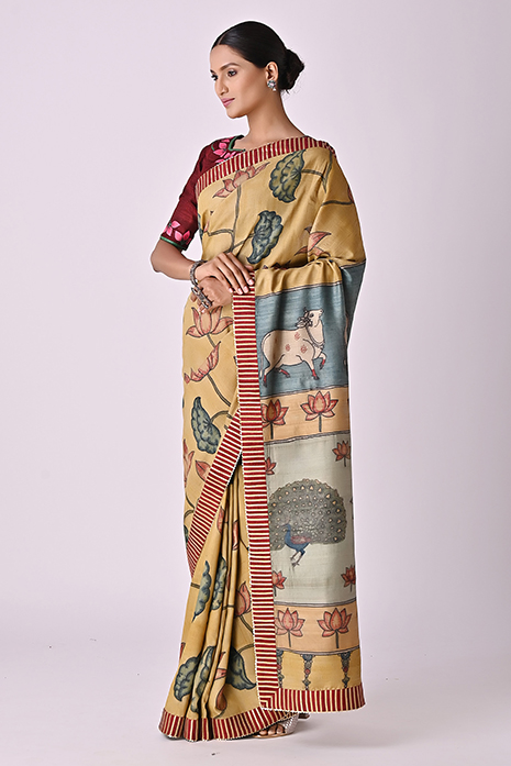 A vibrant collection of light mustard coloured handcrafted sarees with intricate Kalamkari artistry