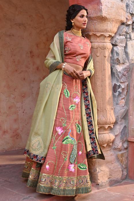 A beautiful hand-painted and hand-embroidered lehenga set in peach colour