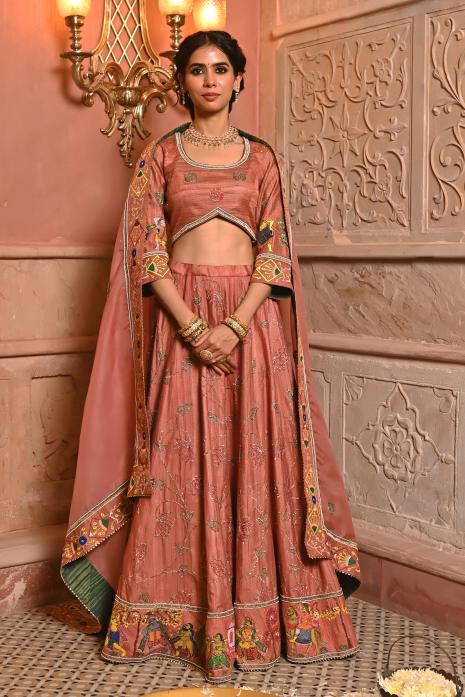 A beautiful hand-painted and hand-embroidered lehenga set in peach colour