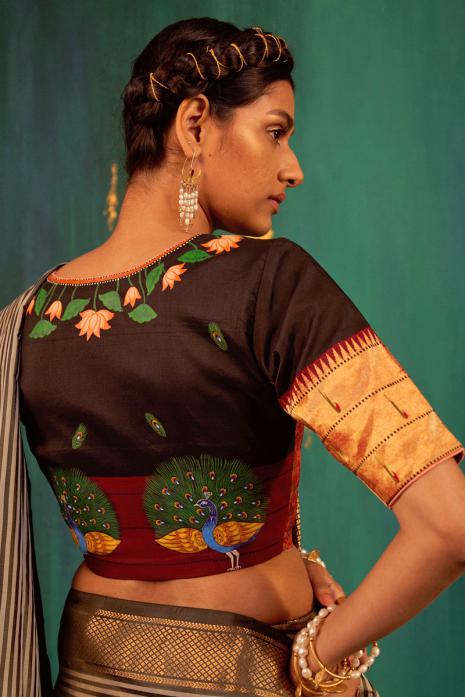 Black coloured Pichwai handpainted blouse crafted from luxurious paithani silk fabric.