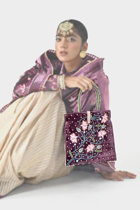 Luxurious and embellished Pichwai velvet bag in purple colour, perfect for giving a glamorous look to your festive outfits