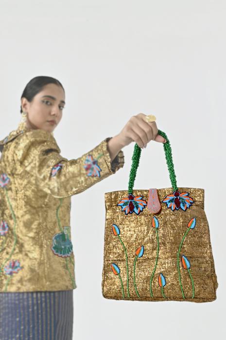 Luxurious and embellished Pichwai gota bag in golden colour, perfect for adding allure to your festive and party wear outfits