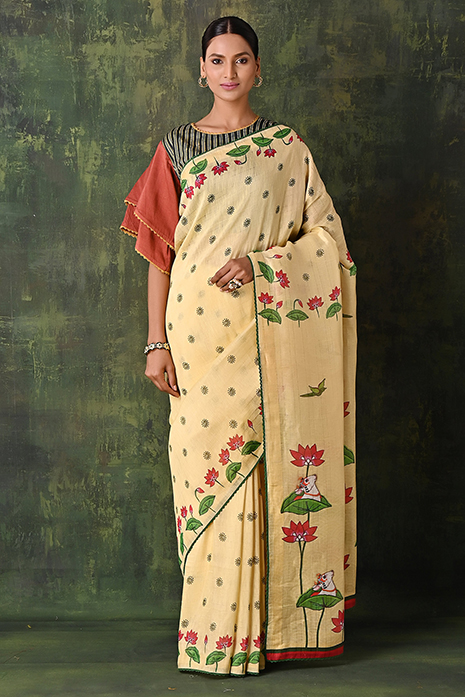 A handwoven tussar linen fabric saree in lemon colour with a beautiful intricate print featuring traditional Pichwai motifs.