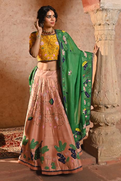 A beautiful hand-painted and hand-embroidered lehenga set in peach colour