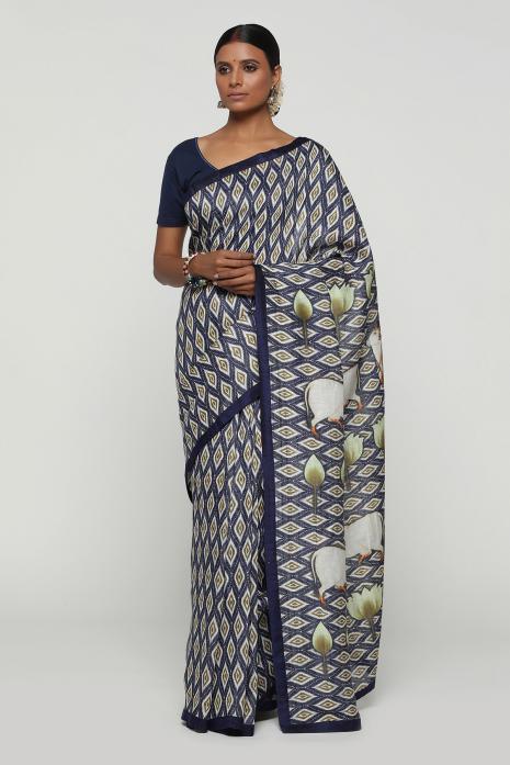 A handwoven tussar linen fabric saree in blue colour with a beautiful intricate print featuring traditional Pichwai motifs.