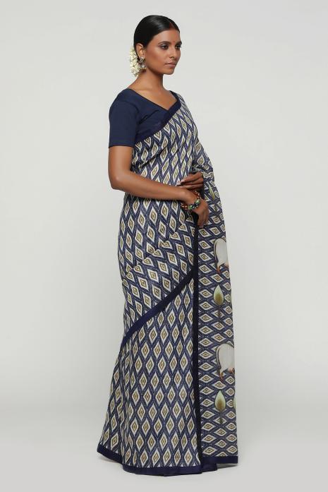 A handwoven tussar linen fabric saree in blue colour with a beautiful intricate print featuring traditional Pichwai motifs.