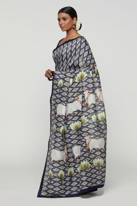 A handwoven tussar linen fabric saree in blue colour with a beautiful intricate print featuring traditional Pichwai motifs.