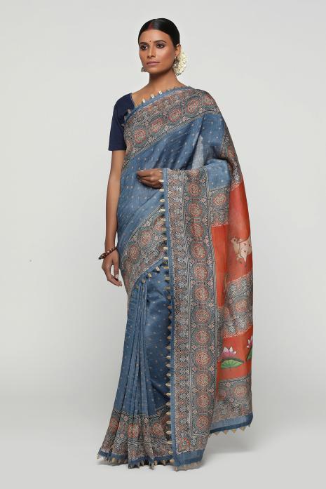 A handwoven tussar linen fabric saree in blue colour with a beautiful intricate print featuring traditional Pichwai motifs.