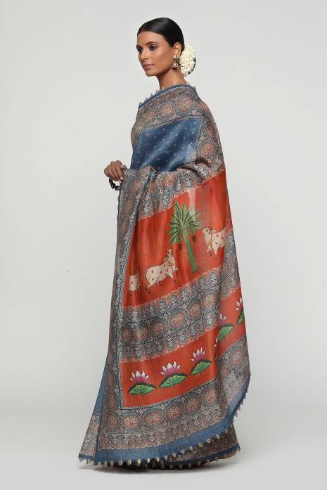 A handwoven tussar linen fabric saree in blue colour with a beautiful intricate print featuring traditional Pichwai motifs.
