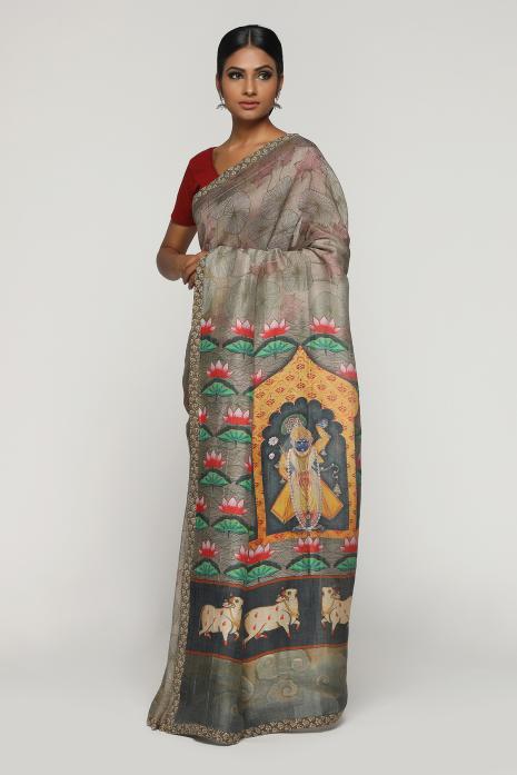 A handwoven tussar linen fabric saree in grey colour with a beautiful intricate print featuring traditional Pichwai motifs.
