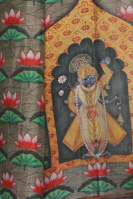 A handwoven tussar linen fabric saree in grey colour with a beautiful intricate print featuring traditional Pichwai motifs.