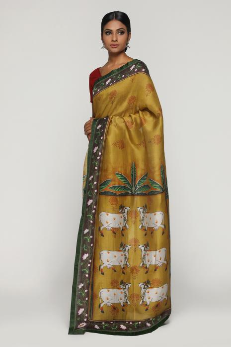 A handwoven tussar linen fabric saree in mustard colour with a beautiful intricate print featuring traditional Pichwai motifs.