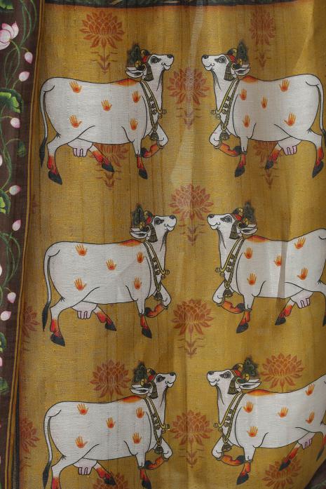 A handwoven tussar linen fabric saree in mustard colour with a beautiful intricate print featuring traditional Pichwai motifs.