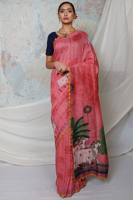 A handwoven tussar linen fabric saree in light pink colour with a beautiful intricate print featuring traditional Pichwai motifs.