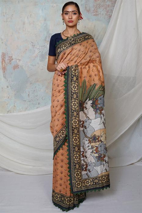 A handwoven tussar linen fabric saree in mustard colour with a beautiful intricate print featuring traditional Pichwai motifs.