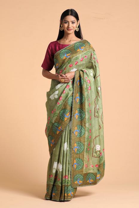 A handwoven tussar linen fabric saree in green colour with a beautiful intricate print featuring traditional Pichwai motifs.