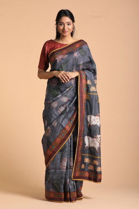 A handwoven tussar linen fabric saree in grey colour with a beautiful intricate print featuring traditional Pichwai motifs.